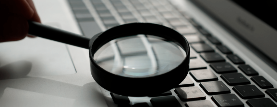 An image of a magnifying glass on a computer, a metaphor for search and search engine optimization (SEO). Credit: Agence Olloweb.
