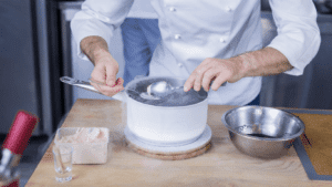 The image shows a cooking show demonstration similar to the ones that Jacques Pépin has put on for years. Businesses could learn a lot from the great French-born chef.