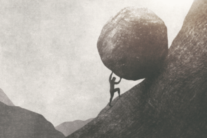 An image that depicts a man rolling a rock up a hill, a metaphor for the marketing challenges facing many small businesses today.