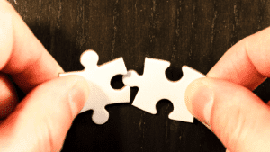 An image of two puzzle pieces fitting together. A metaphor for programmatic advertising, a digital exchange matches advertisers (buyers) with sellers (publishers), who have data on their users.