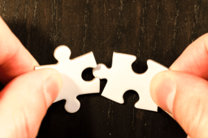 An image of two puzzle pieces fitting together. A metaphor for programmatic advertising, a digital exchange matches advertisers (buyers) with sellers (publishers), who have data on their users.
