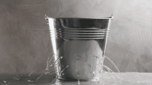 An image that shows a leaky bucket, which metaphorically represents leaks in your marketing funnel. Here we provide that 7 common marketing leaks that we see at different businesses.