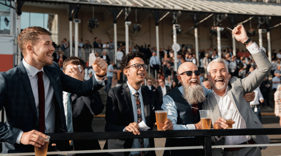 An image that depicts bettors at a racetrack. We give 5 reasons why marketing is like betting on horses.