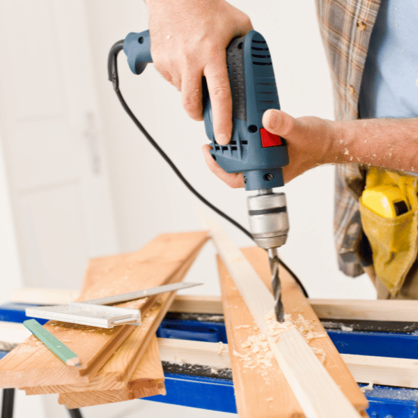 An image of a home builder remodeling a homeowner's house. We help home improvement companies market their services to target homeowners.
